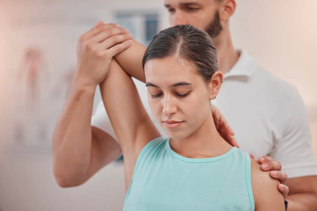 Woman under going a pain management treatment at a chiropractic clinic.