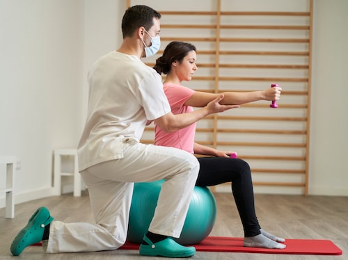 The physiotherapist doing rehabilitation exercises with a patient