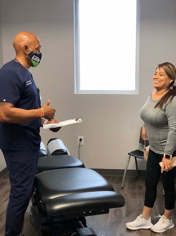 patient smiling while talking to physiotherapist about treatment