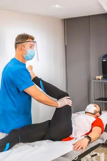 Physical therapist doing a stretch on mans leg | HSRC
