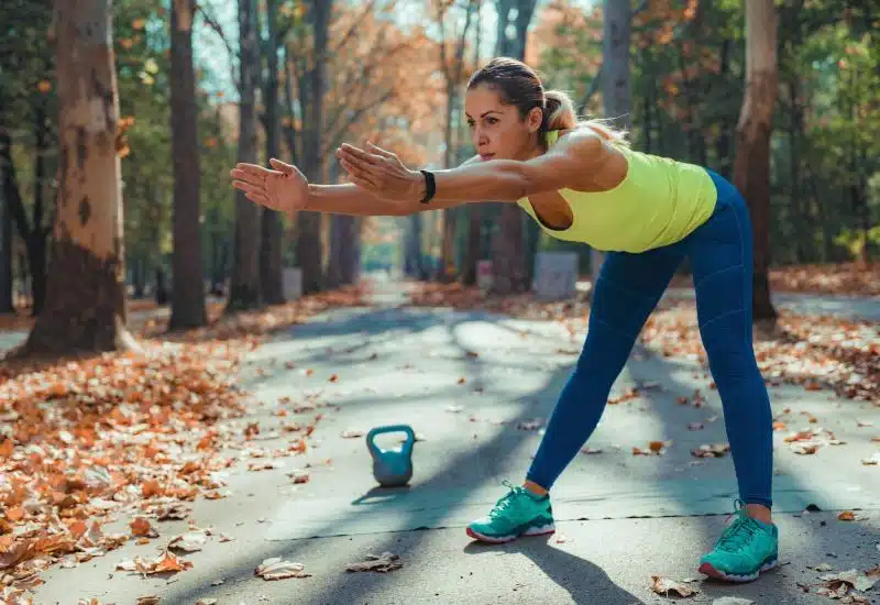 Women doing exercise and stretching in road
