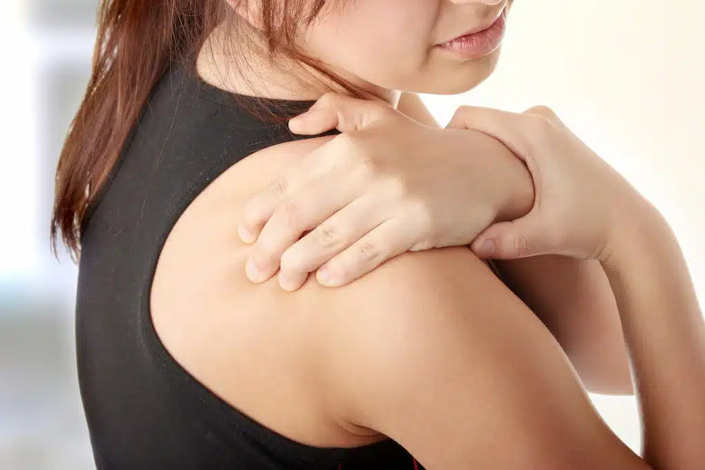 Young woman with pain in her back.