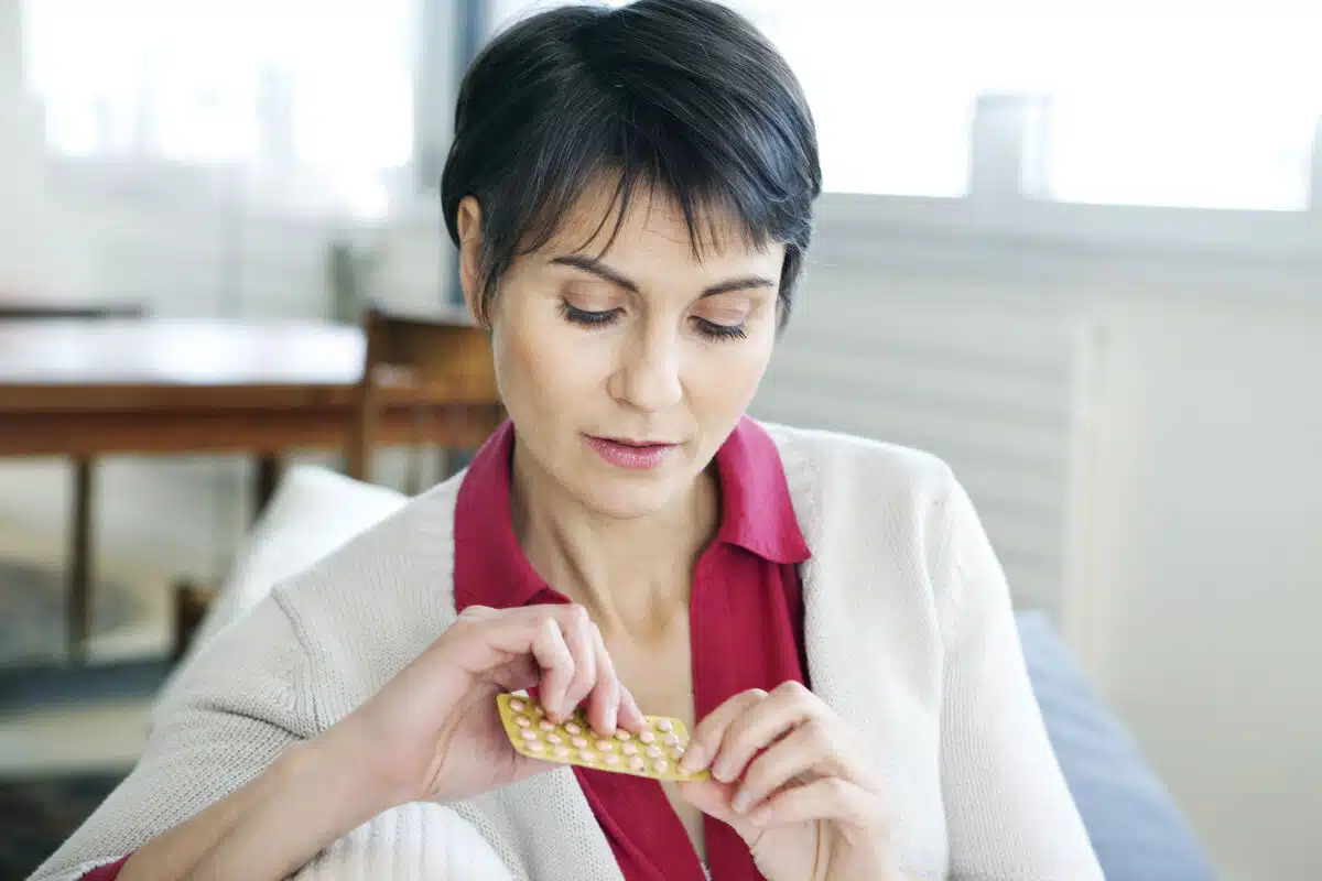 A woman holding a pellets pill