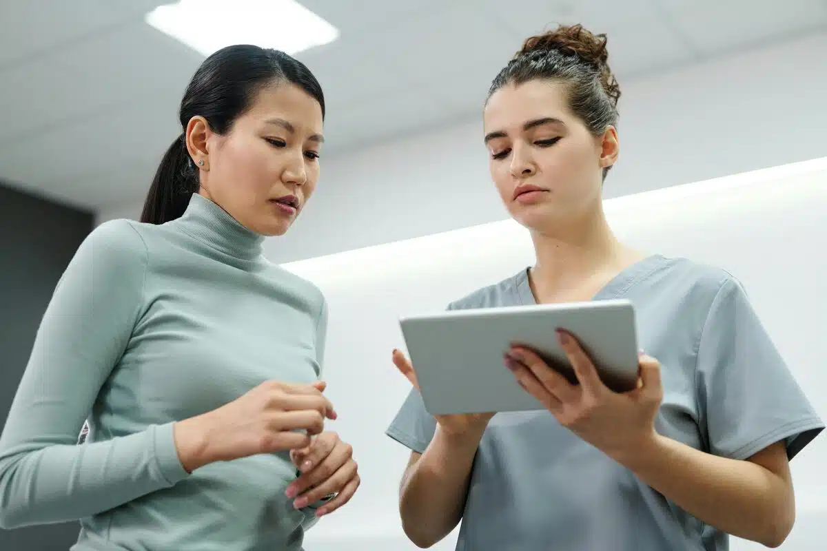 A Medical Specialist and a Patient Looking at a Tablet