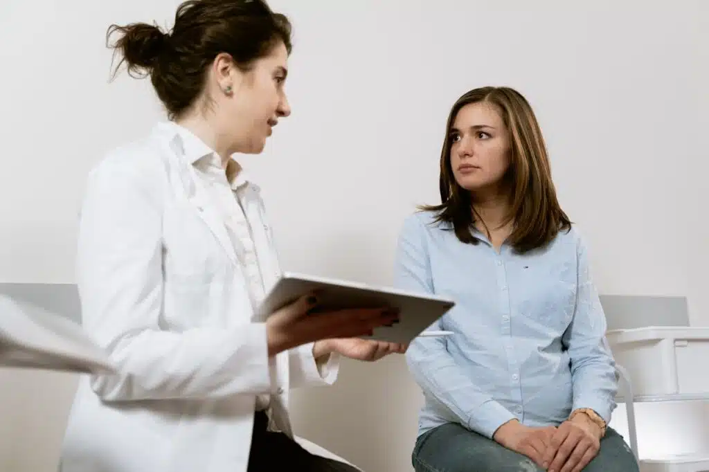 Patient discussing scoliosis symptoms with healthcare provider during consultation