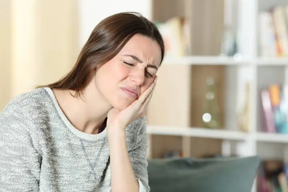 A woman experiencing a jaw pain